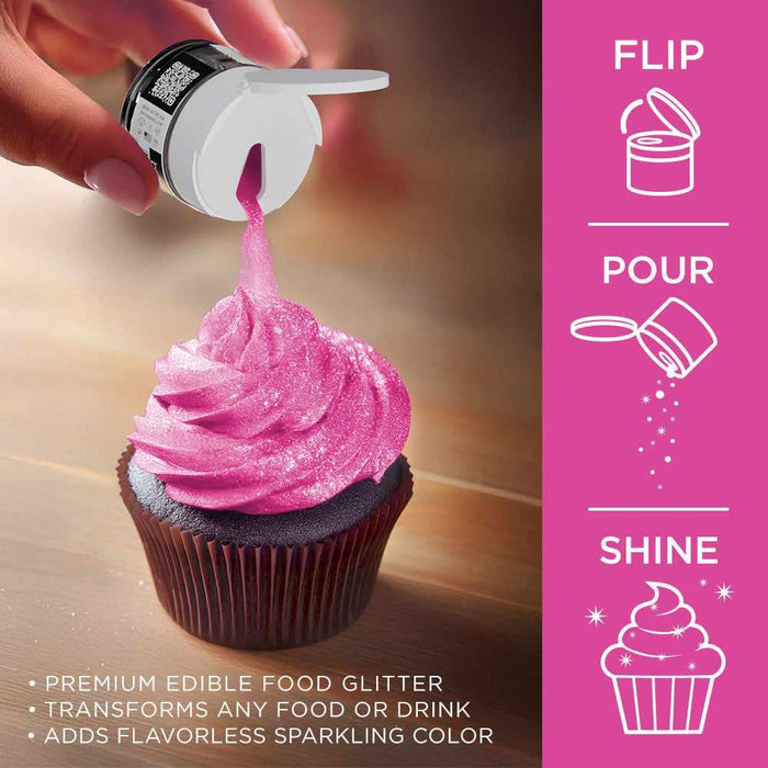 Hand sprinkling neon pink Tinker Dust edible glitter onto a dark chocolate cupcake with pink frosting.
