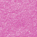 Close-up of vibrant neon pink Tinker Dust edible glitter with sparkling flakes.