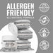 Nu Super Silver Luster Dust in a white jar next to three silver macarons, highlighting allergen-friendly features.
