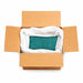 Open cardboard box filled with 132lb of sparkling ocean blue-green ultrafine metallic glitter.