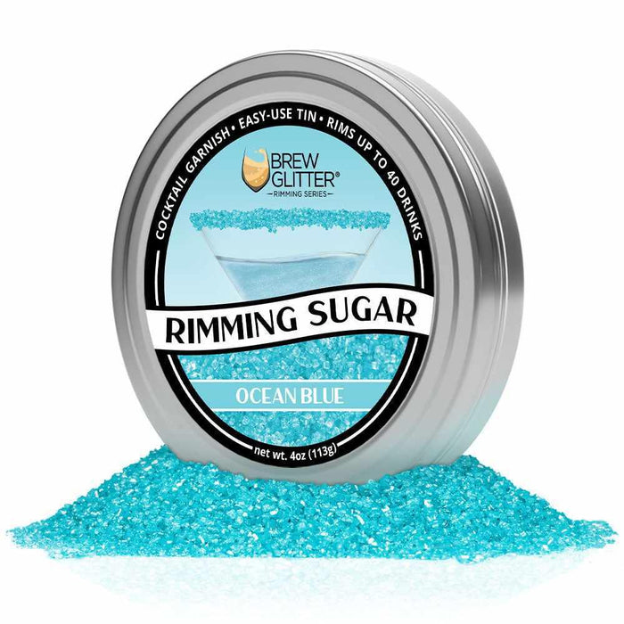 Ocean Blue Rimming Sugar in a round aluminum tin, surrounded by shimmering blue sugar crystals.
