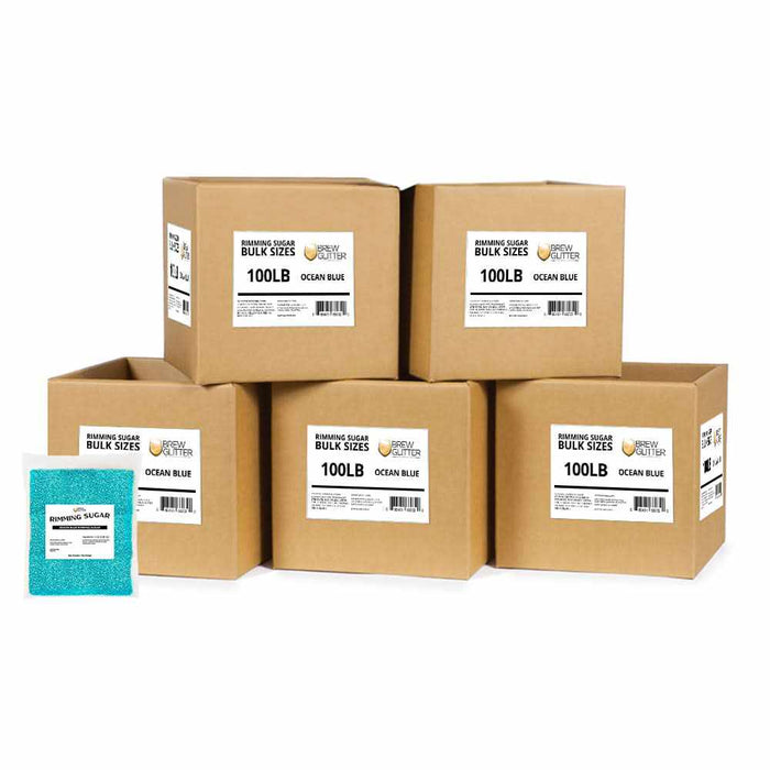 Bulk boxes of Ocean Blue cocktail rimming sugar with a single 1lb bag of blue sugar crystals in front.