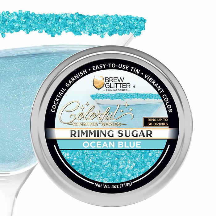 Ocean Blue rimming sugar in a round aluminum tin with a cocktail glass rimmed in vibrant blue sparkling crystals.