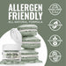 Olive green luster dust in an open jar next to a stack of macarons, highlighting allergen-friendly features.