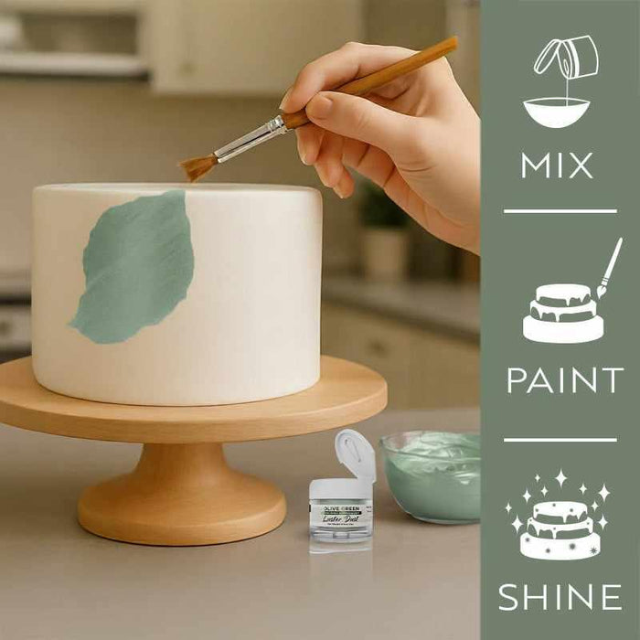 Hand painting an olive green leaf design on a white cake with luster dust, alongside product container and "Mix, Paint, Shine" icons.