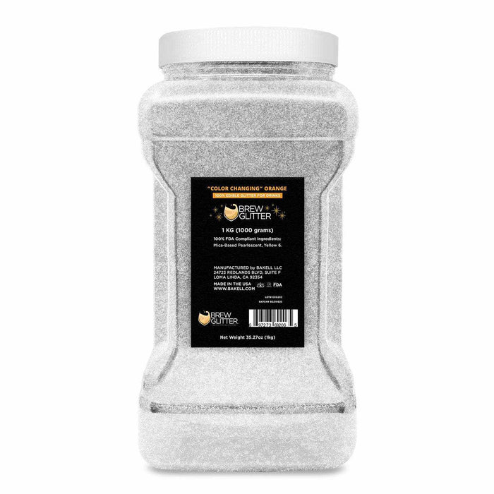 1kg jar of white "Color Changing" Orange Brew Glitter, a food-grade beverage shimmer.