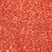 Close-up of vibrant orange shimmering cocktail rimming sugar with a crystalline, sparkling texture for drink garnishes.