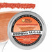 Orange Rimming Sugar in a round aluminum tin, with a cocktail glass rimmed with the sugar in the background.