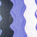Wavy lines of pastel purple iridescent craft glitter on black and white surfaces.