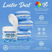 Patriot Blue Luster Dust in a white jar next to blue macarons, highlighting its edible shimmer.