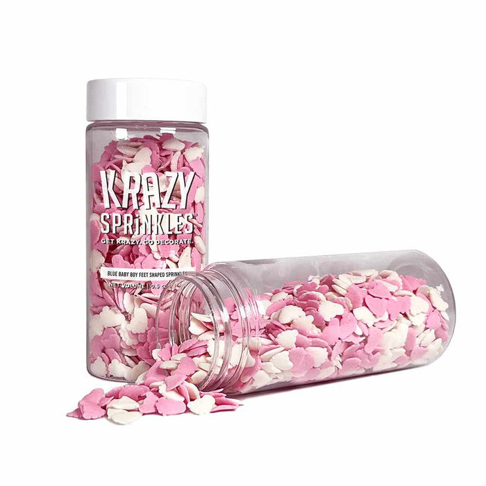 two bottles of pink and white baby feet sprinkles, one bottle is on its side pouring out sprinkles