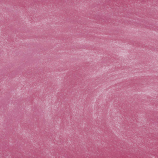 Swirling pink edible glitter particles creating a shimmering, metallic texture for drinks and desserts.