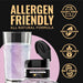 Pink iridescent edible glitter jar with a glass of shimmering purple drink and allergen-free icons on a black background.