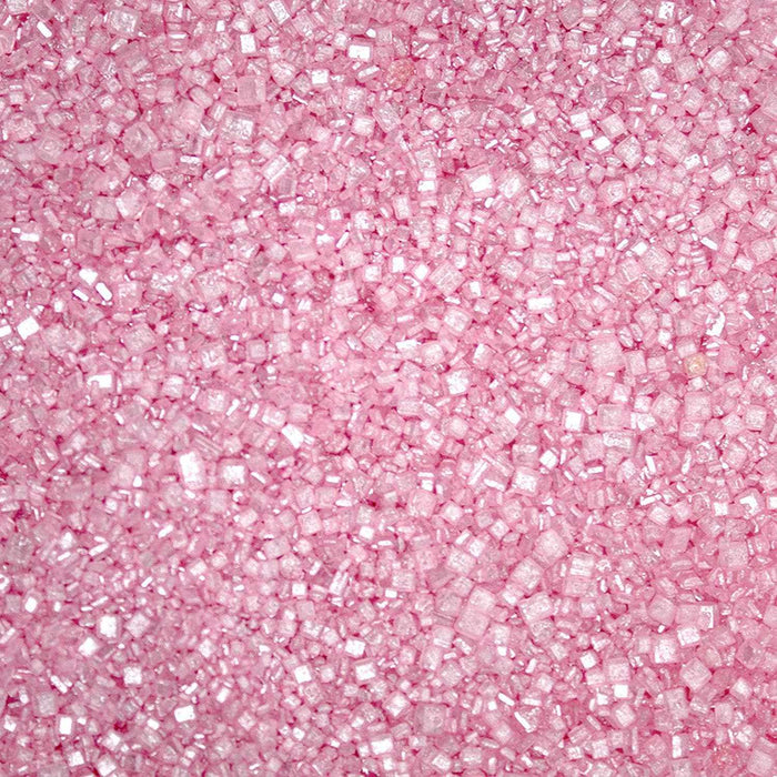 Close-up of sparkling pink pearl cocktail rimming sugar with a textured, crystalline finish for decorating glassware.