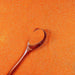 Pumpkin Orange Ultrafine Iridescent Craft Glitter Dazzler Dust, premium polyester, with a wooden spoon.