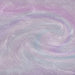 Swirling purple and iridescent holographic edible glitter creating a shimmery, rainbow-effect liquid texture.