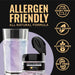 Purple iridescent edible glitter in a jar next to a shimmering purple drink, highlighting allergen-friendly certifications.