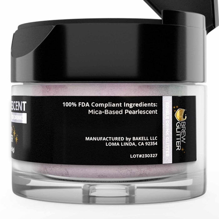 Small jar of purple iridescent edible Brew Glitter with a black lid and product label detailing mica-based ingredients.