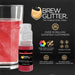 Red Brew Glitter mini spray pump next to a glass of sparkling red drink.