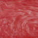 Vibrant red edible drink glitter swirling in a liquid, creating a shimmering, sparkling texture.