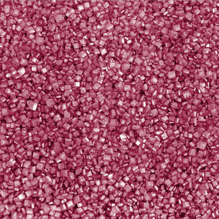 Close-up of vibrant red pearl rimming sugar with a shimmering, crystalline texture for cocktail glass garnishing.