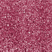 Close-up of vibrant red pearl rimming sugar with a shimmering, crystalline texture for cocktail glass garnishing.