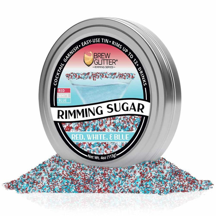 Silver tin of Brew Glitter Red, White & Blue Rimming Sugar, surrounded by a pile of the patriotic sugar crystals.