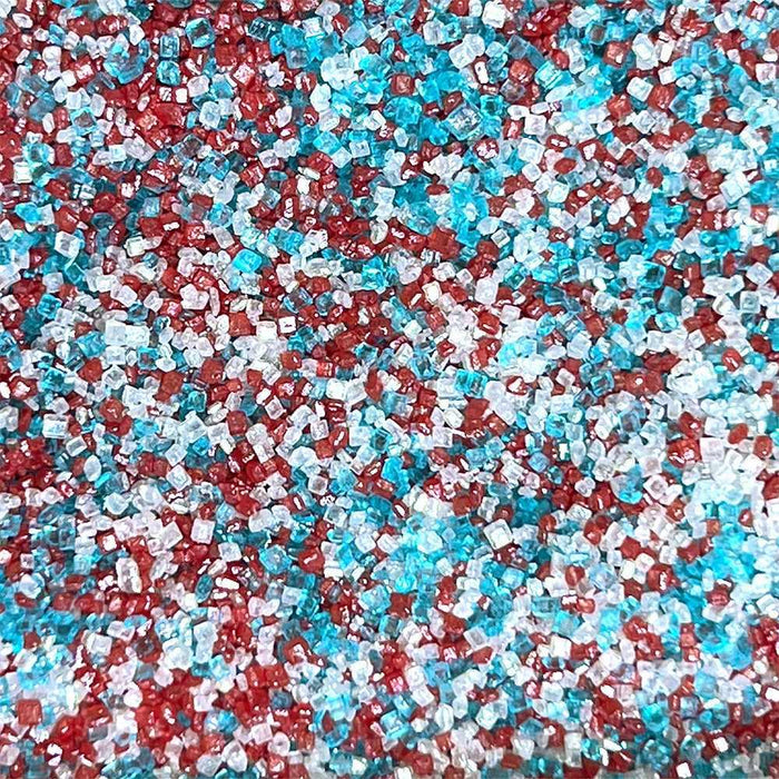 Close-up of sparkling red, white, and blue cocktail rimming sugar crystals.