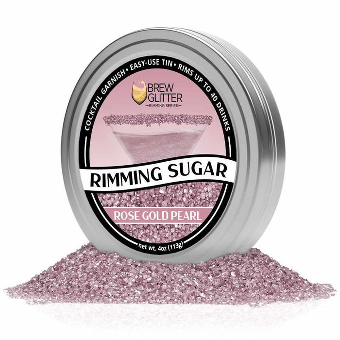 Rose Gold Pearl Rimming Sugar in a silver tin, surrounded by loose rose gold sugar crystals.