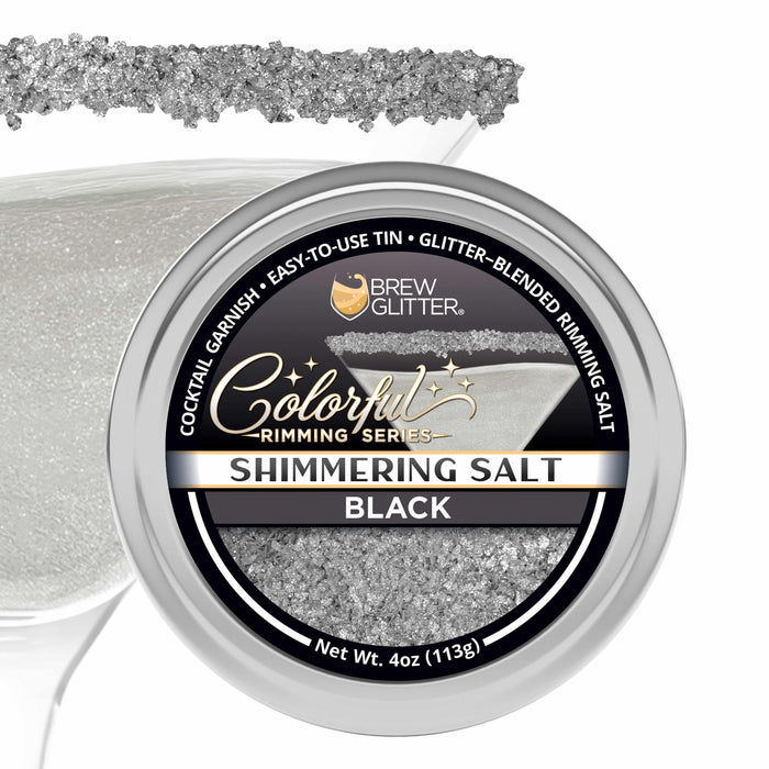Shimmering black cocktail rimming salt in a 4oz tin with a glittery texture, shown with a garnished martini glass rim.