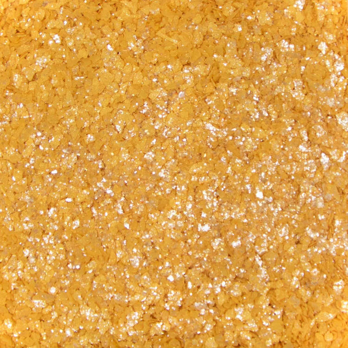 Close-up texture of shimmering gold cocktail rimming salt with sparkling, coarse crystalline grains for drink garnishing.