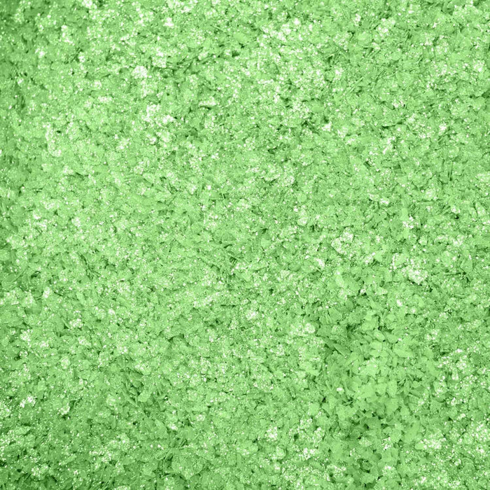 Close-up texture of shimmering, vibrant green cocktail rimming salt with a sparkling, crystalline finish.