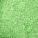 Close-up texture of shimmering, vibrant green cocktail rimming salt with a sparkling, crystalline finish.