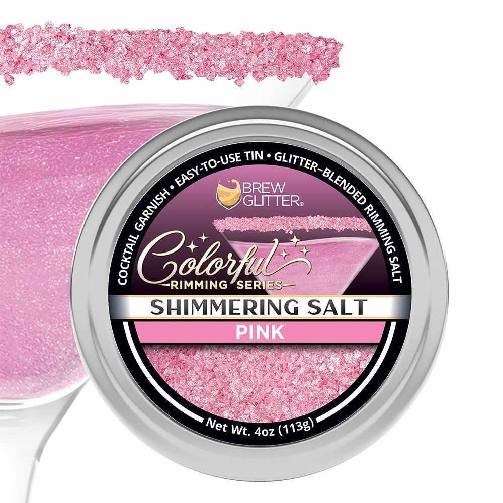 4oz tin of shimmering pink cocktail rimming salt with a glittery texture, displayed next to a pink-rimmed martini glass.
