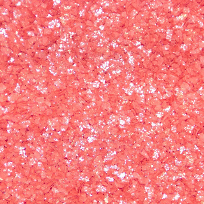 Close-up texture of vibrant red cocktail rimming salt with a shimmering, glittery finish for drink garnishes.