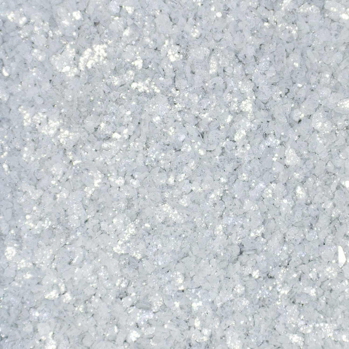 Close-up texture of shimmering silver cocktail rimming salt with a glittery, crystalline finish for drink garnishes.