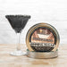 Silver Pearl Cocktail Rimming Sugar in a tin, next to a martini glass with a black sugar rim.