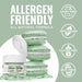 Soft green edible luster dust in a jar next to three macarons, with allergen-friendly icons.