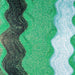 Soft Shamrock green iridescent ultrafine craft glitter with wavy black and white stripes.