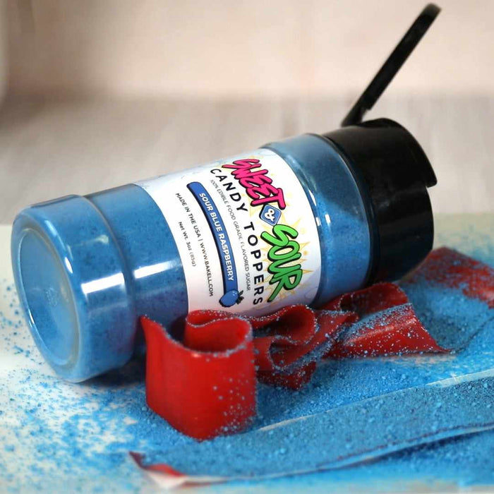 Blue Sour Blue Raspberry candy toppers shaker bottle, 3oz, with powder spilled and red candy strips.