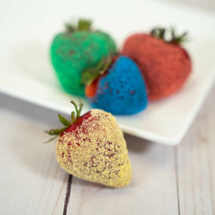 Juicy strawberries adorned with yellow Sweet & Sour Candy Toppers | Tangy twist of banana flavor | Berrylicious decorations