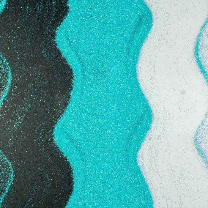 Wavy lines of turquoise ultrafine iridescent craft glitter, black glitter, and white glitter.
