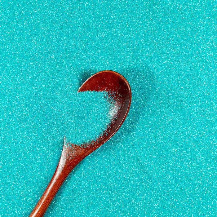 Turquoise ultrafine iridescent craft glitter with a wooden spoon, premium non-toxic polyester.