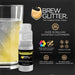 Yellow color-changing brew glitter mini spray pump next to a sparkling drink.