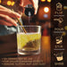 Hand pouring white color-changing brew glitter from a shaker into a glass, transforming liquid to yellow.