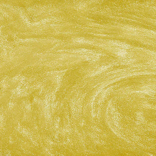 Swirling yellow edible glitter particles creating a shimmering, metallic gold texture in a liquid beverage.