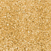 Close-up texture of shimmering yellow pearl cocktail rimming sugar with coarse, crystalline grains.