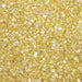 Close-up texture of sparkling yellow pearl cocktail rimming sugar with coarse, crystalline granules.