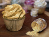 Cupcake cover in Gold Edible Glitter, and a Jar Spilled with Golden Edible Glitter to the Right | bakell.com