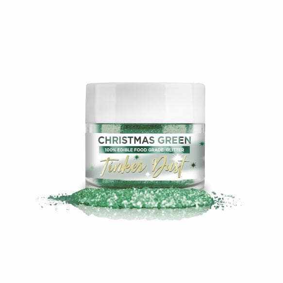 Christmas Green Tinker Dust edible glitter in a clear 5g jar with a white lid, spilled on a white surface.